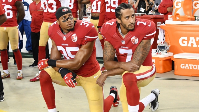Colin Kaepernick kneels in protest during the national anthem.