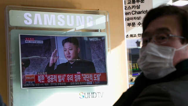 A South Korean man in front of a TV with North Korean leader Kim Jong-un onscreen.