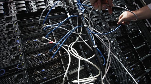 A rack of computer servers and cords