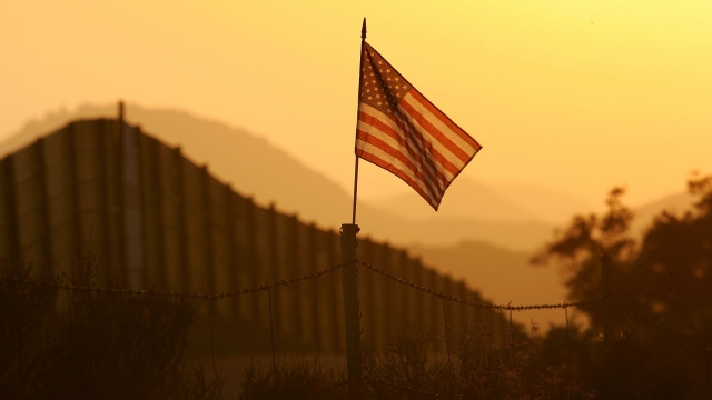 American flag and border fence