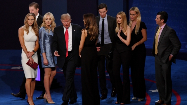 Donald Trump stands on stage with members of his family.