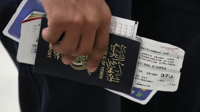 A man holds travel documents after arriving in the U.S.