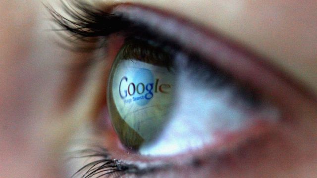 Photo illustration of Google logo reflected in eye