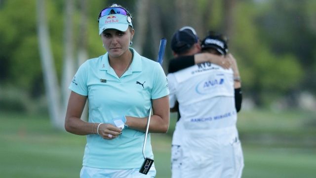 Lexi Thompson walks away from putting green.