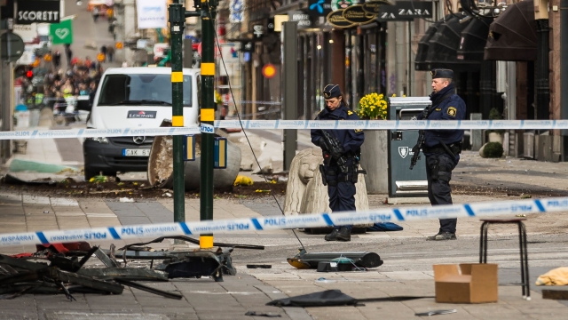 Police attend the scene of the terrorist attack where a truck crashed after driving down a pedestrian street in Stockholm.