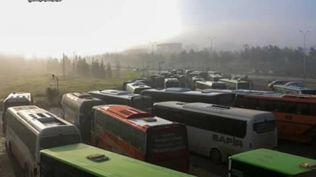 Buses ready to carry Syrians away from war-torn towns in government exchange