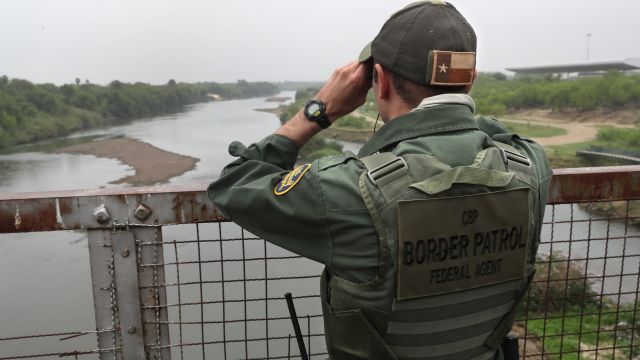 U.S. Border Patrol agent scans the U.S.-Mexico border