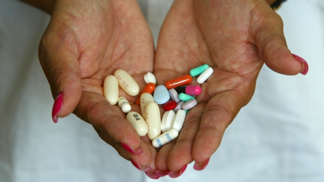 A patient displays 14 different AIDS medications she takes.