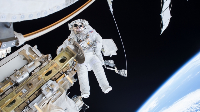 Astronaut performing spacewalk outside of International Space Station