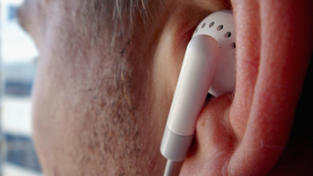Man listening to music through earbuds
