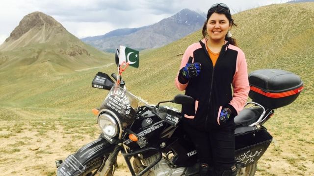 Pakistani activist poses with her motorcycle
