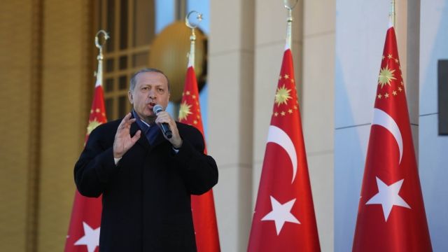 Turkish President Recep Tayyip Erdogan in front of Turkish flags