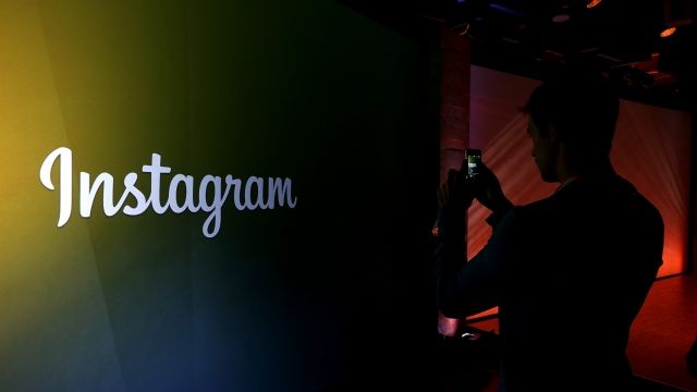 Person stands in front of Instagram sign