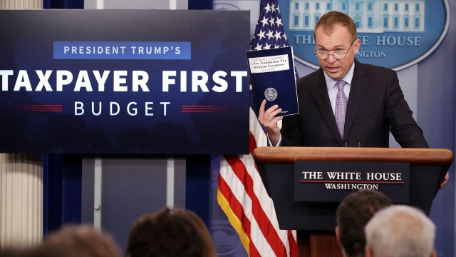 Office of Management and Budget Director Mick Mulvaney holding a copy of President Trump's budget proposal.