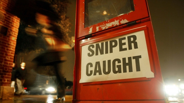 Newspaper box headline reading 'Sniper Caught'