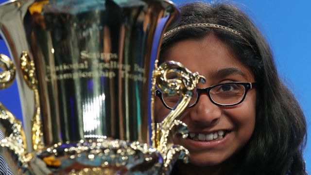 Ananya Vinay holds up her trophy for winning the Scripps National Spelling Bee