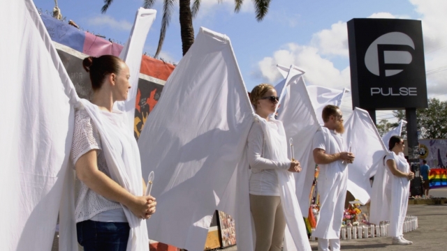 People dressed as angels stand outside Pulse nightclub.