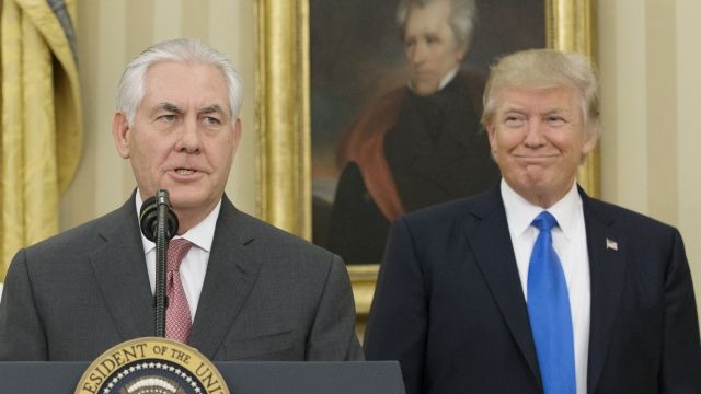 Rex Tillerson and Donald Trump stand at a podium