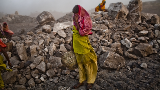 A girl works at a coal mine in India