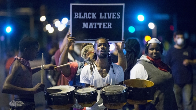 Demonstrators, marking the one-year anniversary of the shooting of Michael Brown, protest.