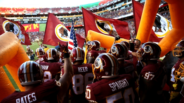 Washington Redskins players entering the field.