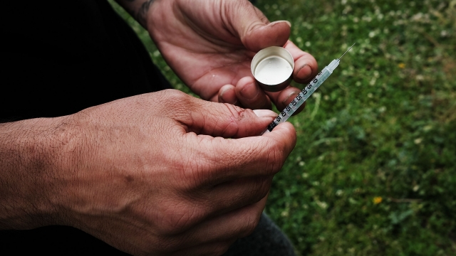 A man shoot heroin in a park in the South Bronx.
