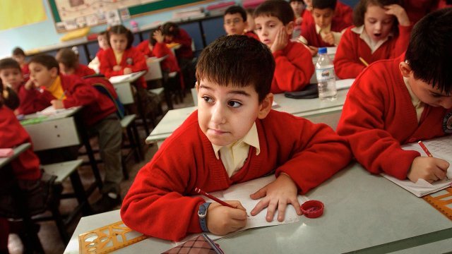 A six-year-old Kurdish boy, attentively watches a lesson given in Turkish.