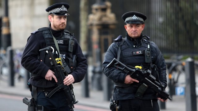 Armed officers outside Westminster Bridge and the Houses of Parliament in London.