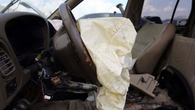 A deployed airbag is seen in a Nissan vehicle.