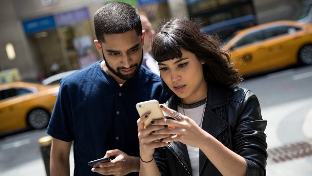 Two individuals play Pokémon GO In New York City