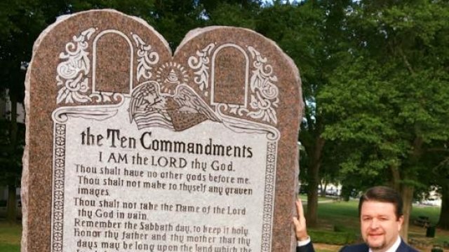 Arkansas State Sen. Jason Rapert stands next to the controversial Ten Commandments monument.