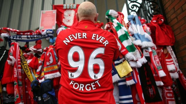 A Liverpool fan pays respects at a Hillsborough memorial
