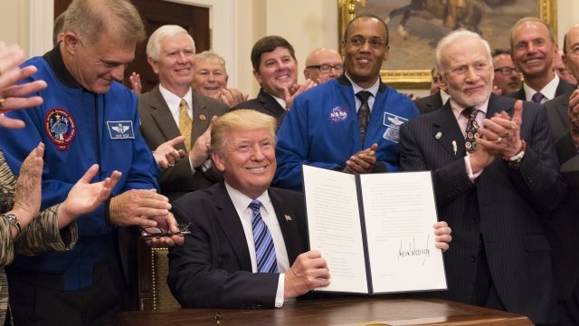 President Trump shows off the executive order recreating the National Space Council.