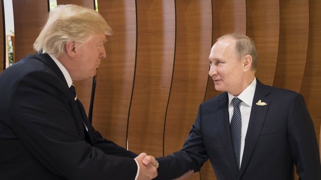U.S. President Donald Trump shakes hands with Russian President Vladimir Putin