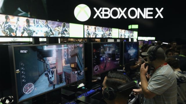 Gamers play Xbox One X at E3 booth