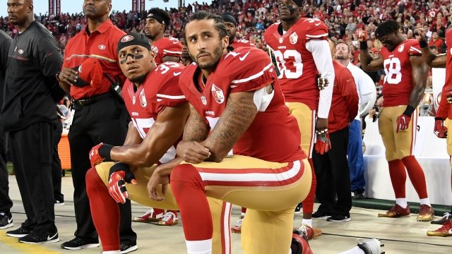 Colin Kaepernick kneels in protest of the national anthem.