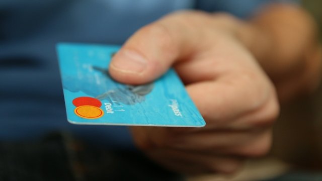 Man holding debit card in one hand