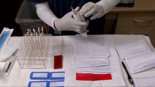 A forensic nurse organizes blood samples.