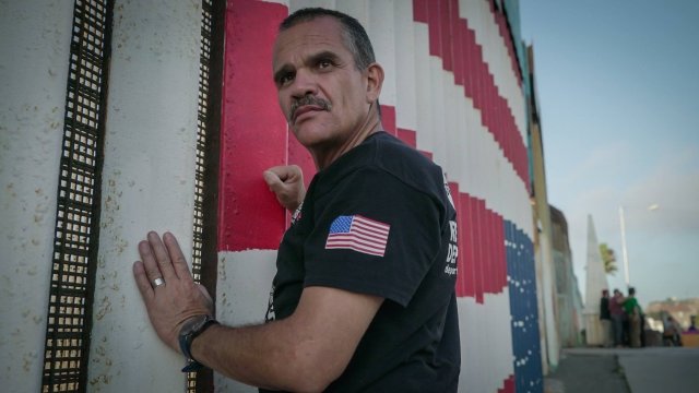 Deported veteran Alex Gomez stands by border to the United States.