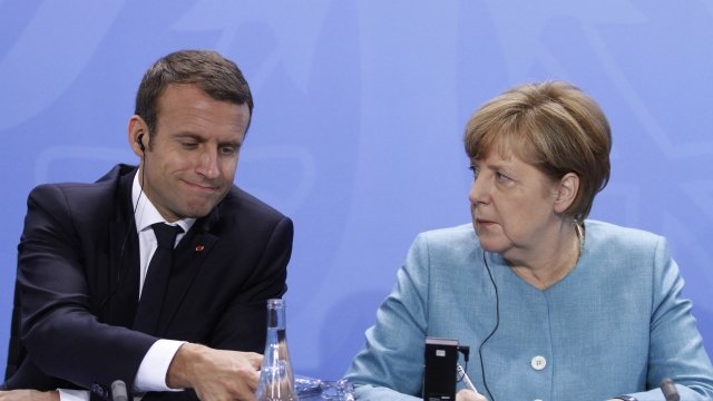 France's Emmanuel Macron and Germany's Angela Merkel speak.