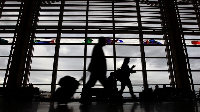 Passengers walk in an airport