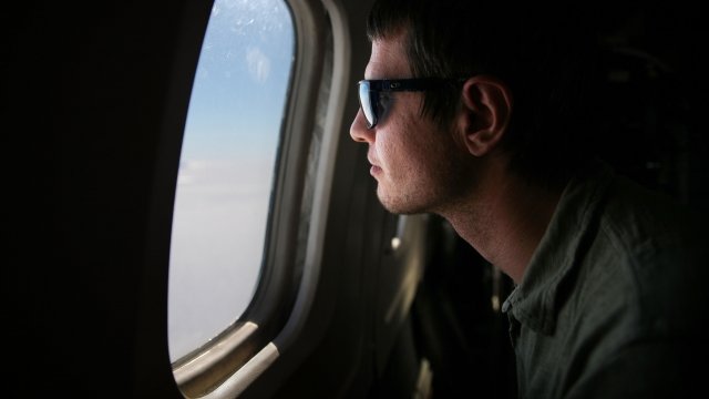 IceBridge Project Scientist Nathan Kurtz looks out of a plane window
