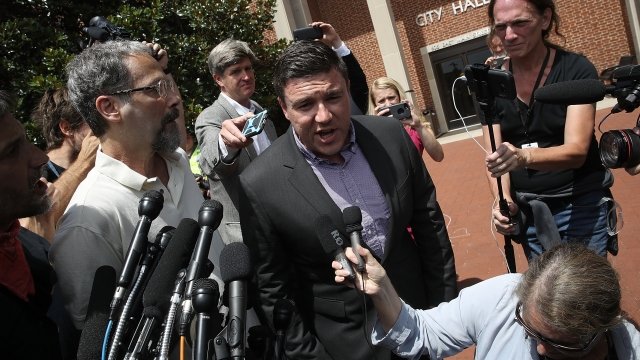 Jason Kessler surrounded by journalists and protesters.