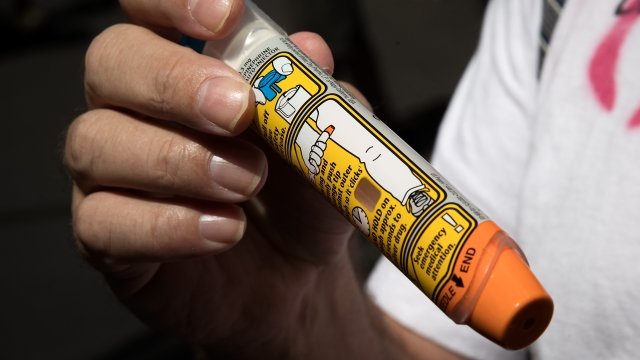 A person holds an EpiPen