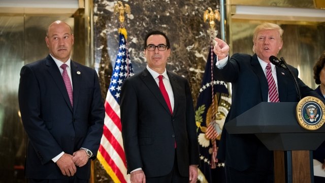 Gary Cohn (left), Steven Mnuchin (center) and President Donald Trump