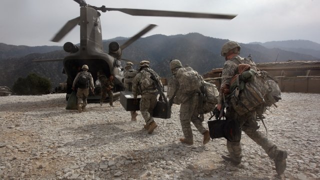 U.S. soldiers board Army Chinook transport helicopter after it brought fresh soldiers and supplies to the Korengal Outpost.