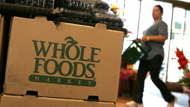 Whole Foods box in store with person walking in background