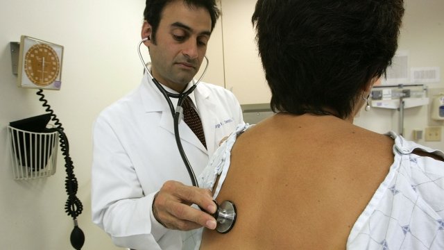 A doctor examines a patient.