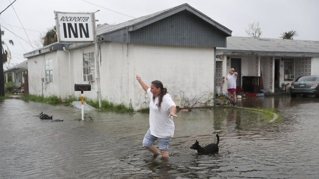Woman walks through flood after Hurricane Harvey