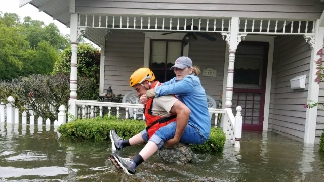 A National Guard soldier helps a woman in Houston.